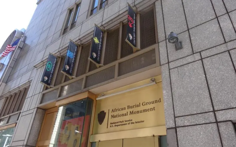 Entrance to visitor center with four banners above doorway.