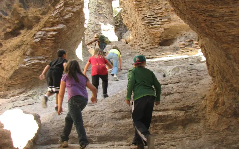 Children climb through rock archways