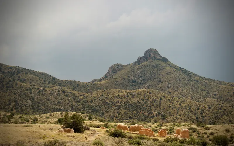 Ruined walls of the old buildings and mountains in the background