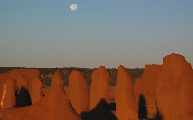 Moon in sky above adobe remnants