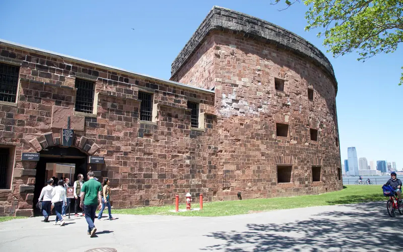 Front of sandstone brick fort with arched entrance way.