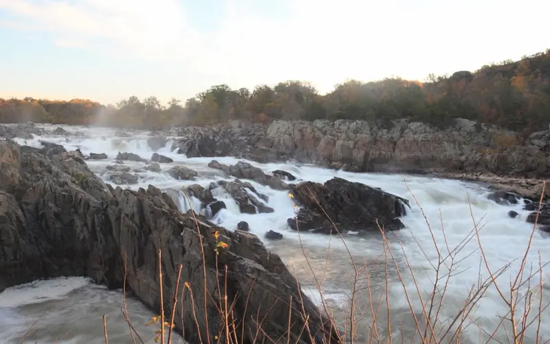 Water rushes over jagged rocks
