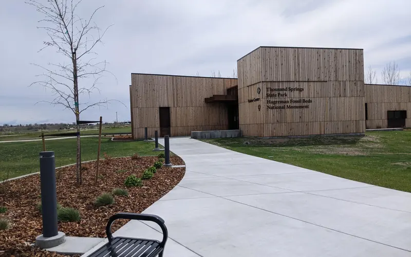 A sidewalk leads to a boxy, wood-paneled building labelled as "visitor center"