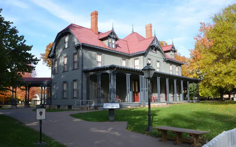 a large gray house with a red roof
