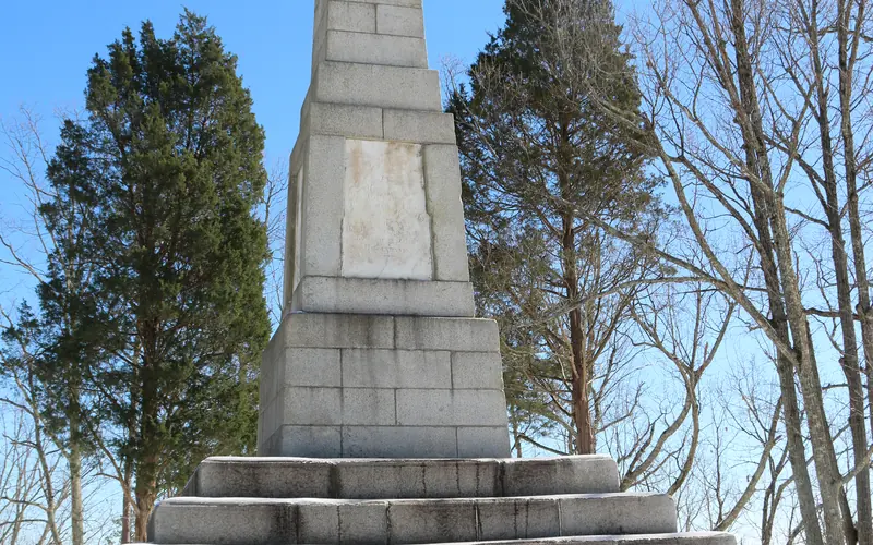 Snow covers the ground in front of the Centennial Monument.