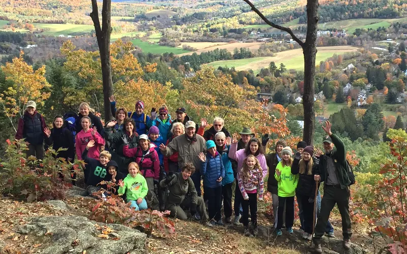 Hikers enjoying fall foliage during a park event
