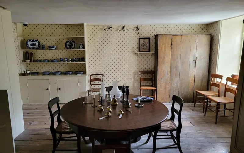 The servants' dining room in the basement of Lindenwald. A round table fill the center of the room.