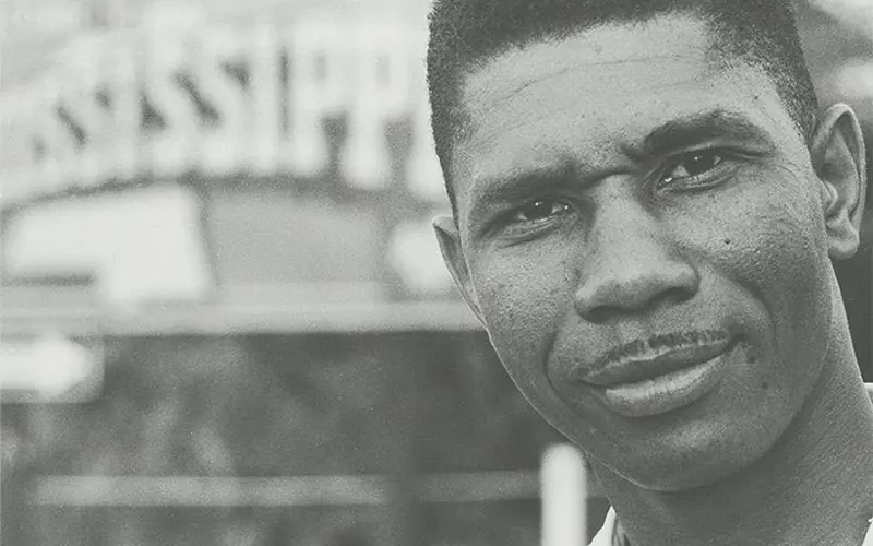Close up black and white portrait of a black man with a thin mustache