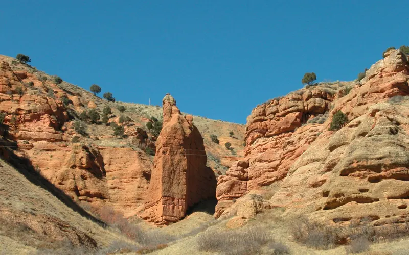 Red rock monolith in a rocky canyon