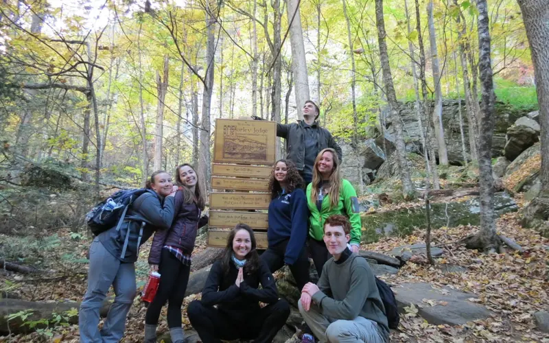 Youth gather around a trail head