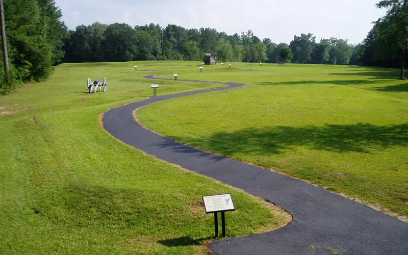 The walking trail winds past a cannon and a rifle tower.