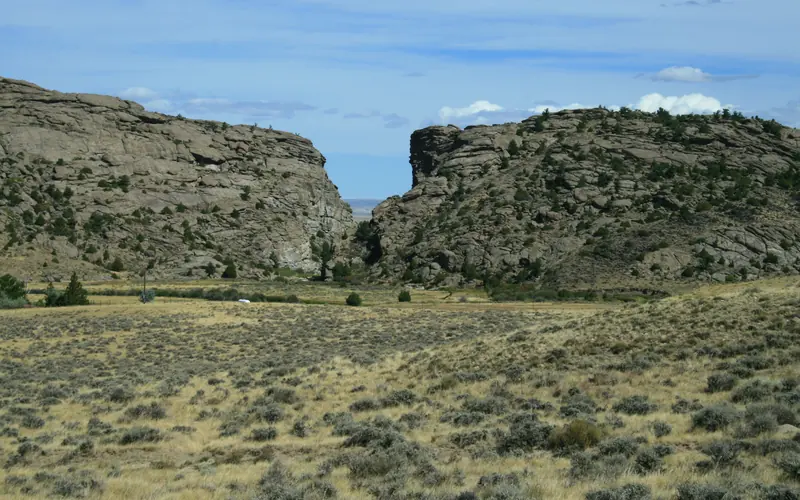 A rock buttress with a notch in it surrounded by sagebrush flats.