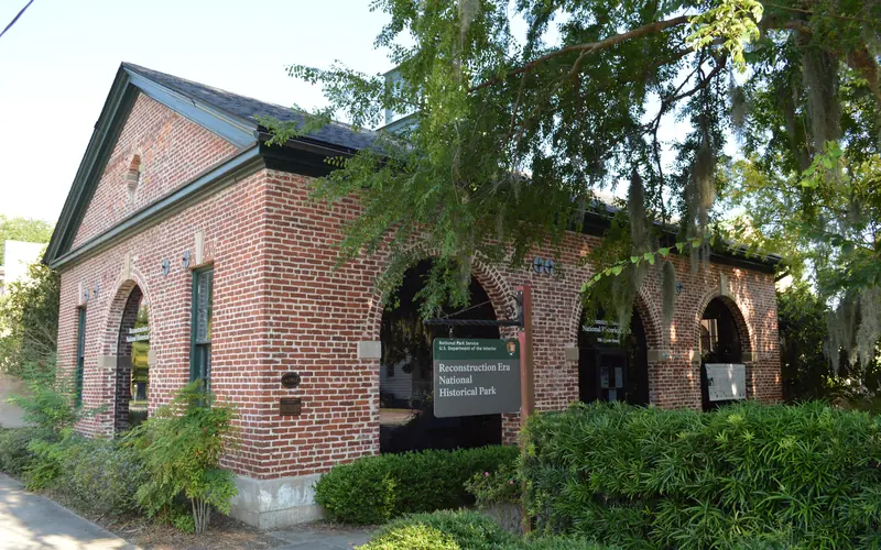 A one story brick building with large arched windows