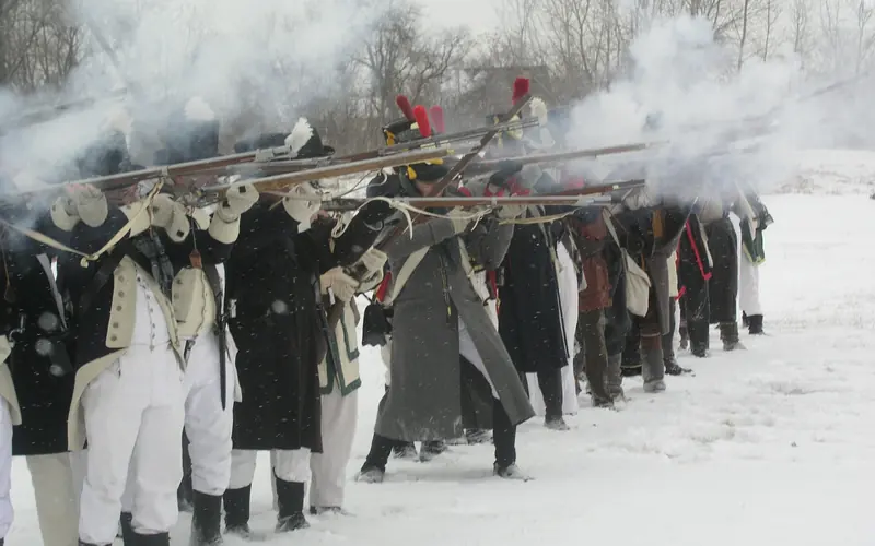 re-enactors firing in a battle line