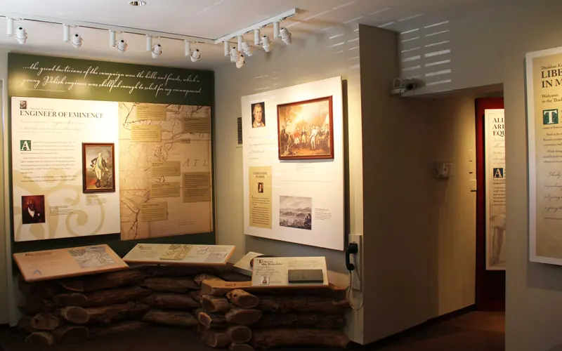 Photo of exhibit area with exhibit panels showing images, text, and a map of the eastern U.S.