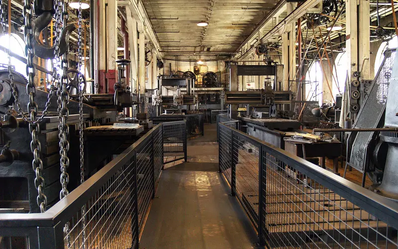 Large work space room with machines connected to belts and pullies