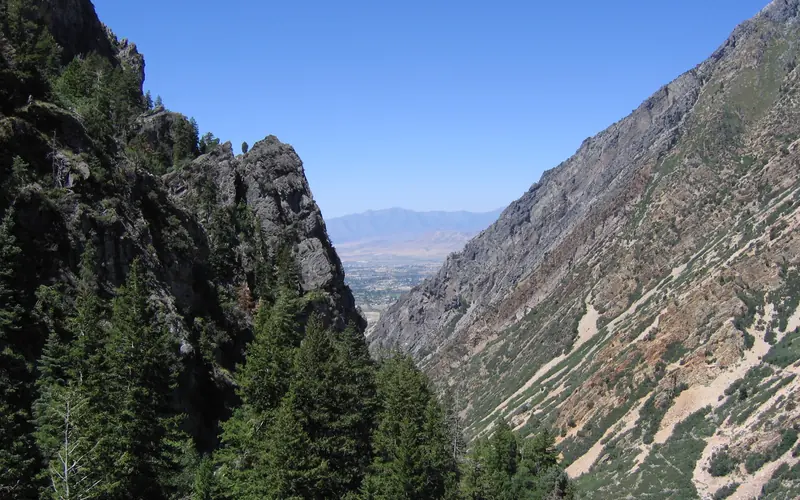 Utah Valley beyond the steep cliffs and fir trees of American Fork Canyon