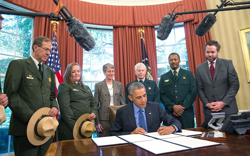 President Obama signs order viewed by members of National Park Service