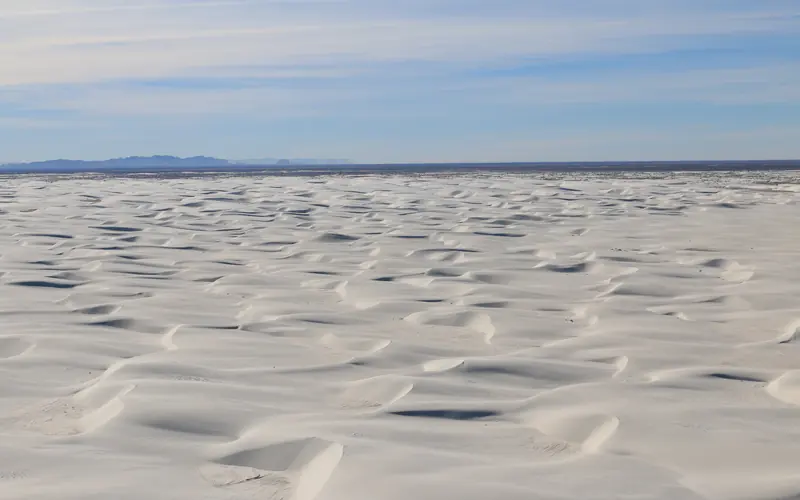 Aerial of white sand dunes.