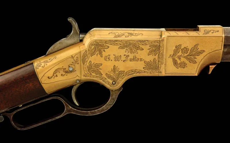 The receiver of an 1864 rifle shows decorative engraving with the original owner's name